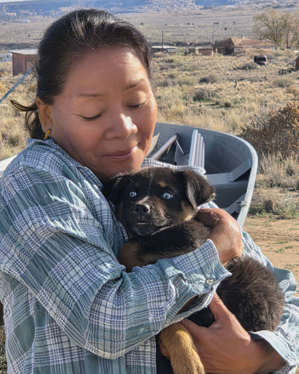 Denise holding blue eyed puppy